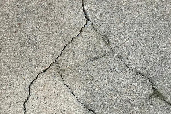 A cracked concrete slab that needs to be broken out and replaced