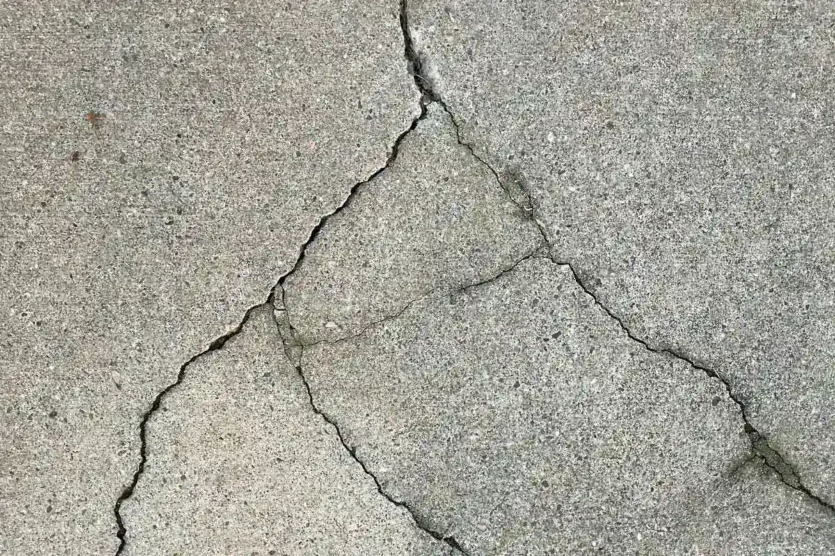 A concrete slab split by branching cracks