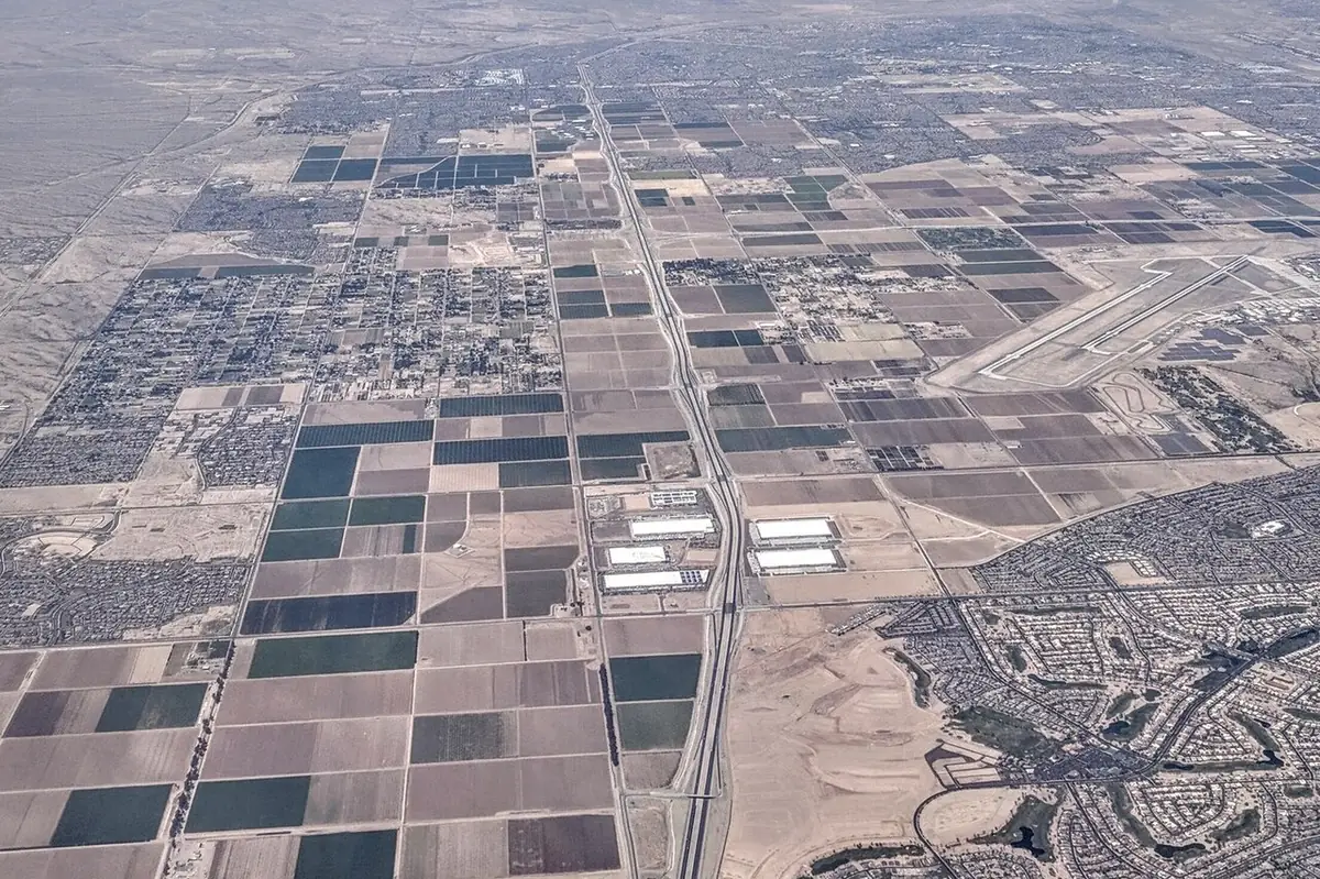 Aerial view of farmland, new subdivisions and the I-10 and Loop 303 interchange in Goodyear, Arizona