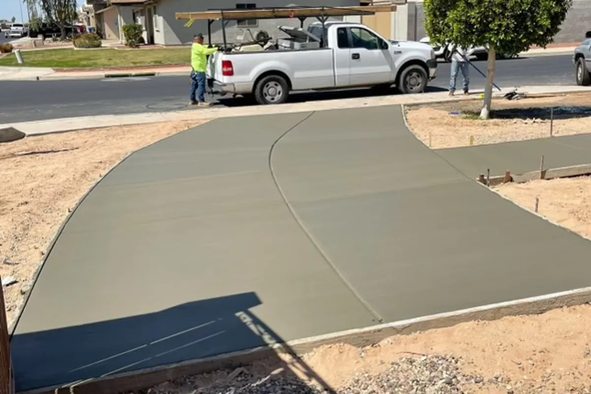 A freshly poured curved concrete driveway extension in the Phoenix area, by our featured contractor