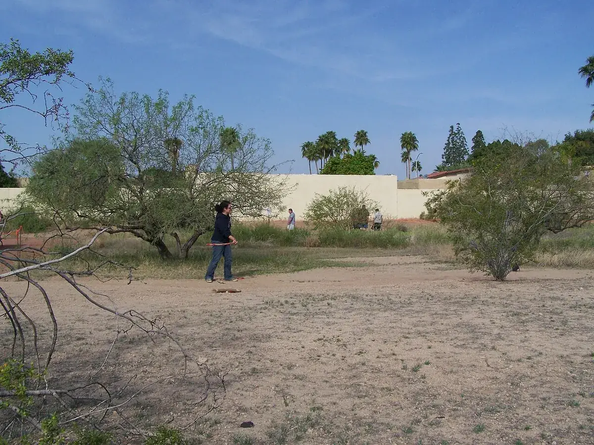 Open desert ground inside a block wall in Mesa, Arizona