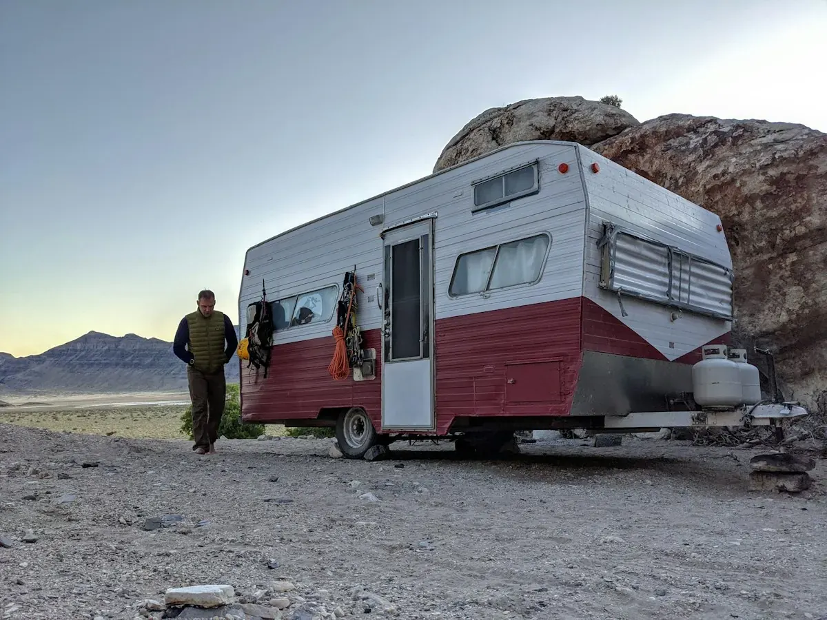 A travel trailer parked on rocky ground in the Arizona desert